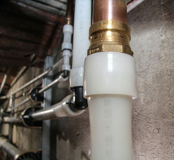 Uponor copper press adapter transition to PEX in hybrid plumbing installation