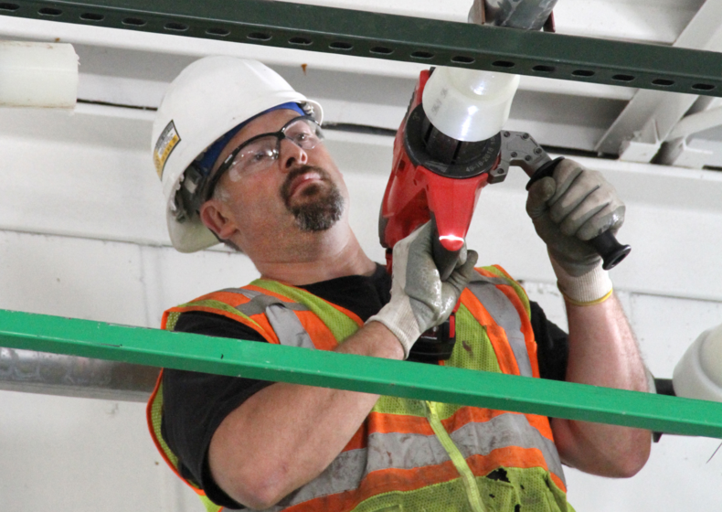a live action shot of a contractor installing PEX at the Uponor manufacturing Annex